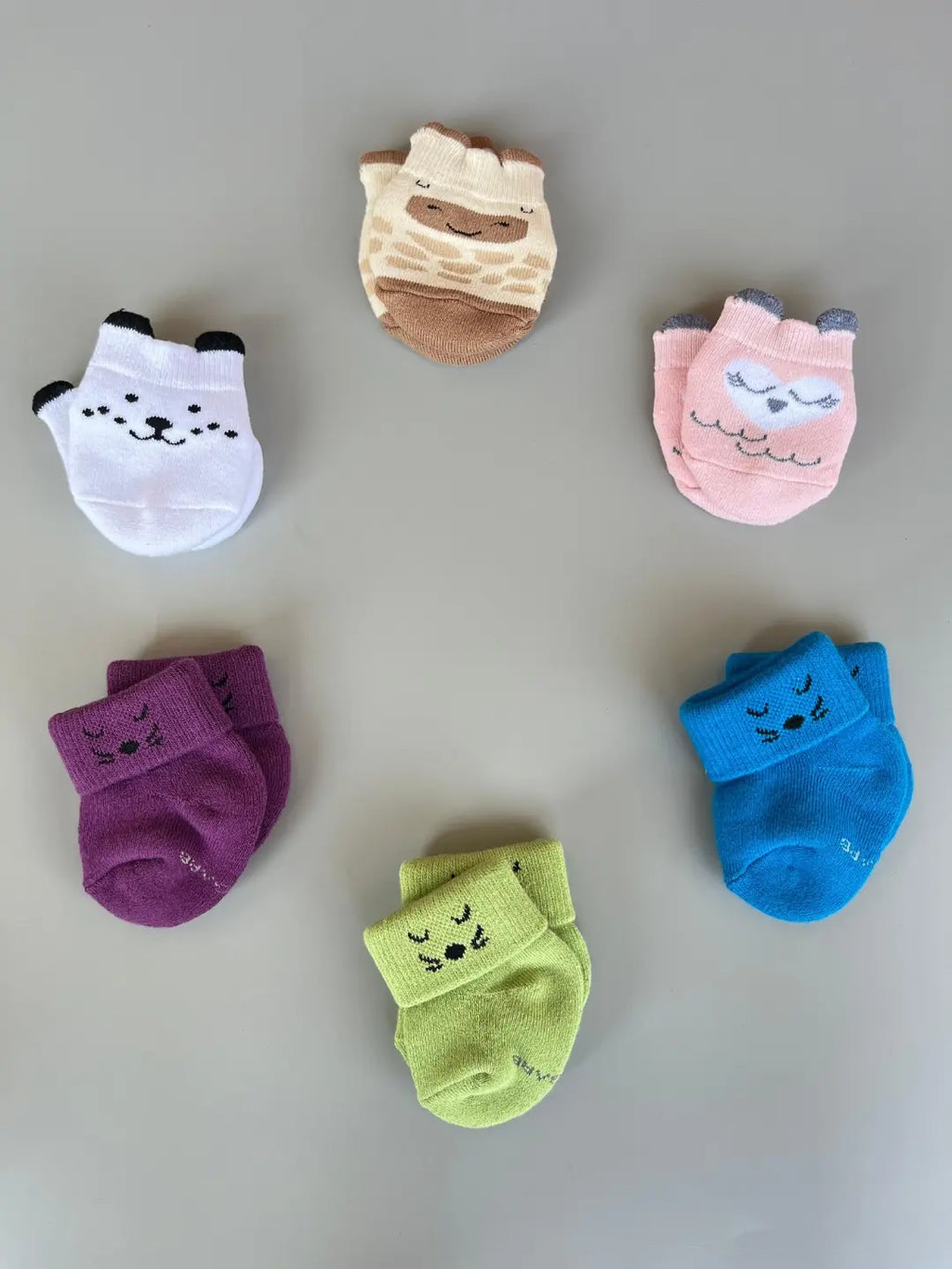 Air Garb baby combo socks for infants 0-1 years; a 6-pair collection arranged in a circle featuring animal faces like pink owl